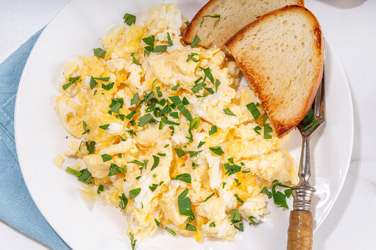 Traditional breakfast scrambled eggs with toasted bread