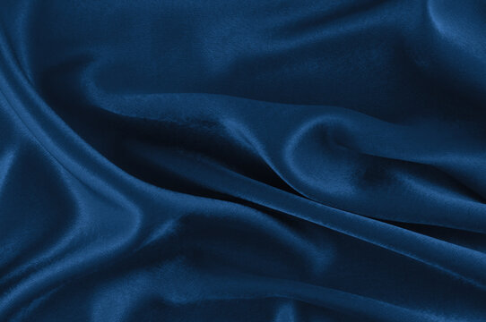 Blue silk fabric texture with soft folds