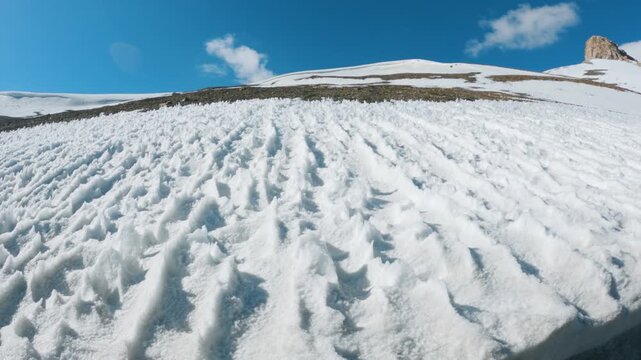 4K shot of Penitentes or or nieves penitentes formed at the high altitude mountain pass at Tanglang La on Leh Manali highway during the summer season. Scenic view of snow in high altitudes of Himalaya