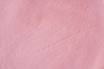 Close up detail of soft fluffy warm light pink material textile texture background for crafts © reddish