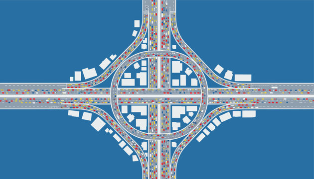 High angle view of a busy highway cloverleaf interchange with dense colorful car traffic flowing on multiple lanes.