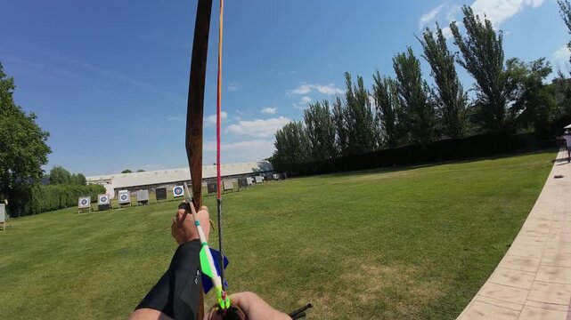 Archer releasing arrow towards target pov
