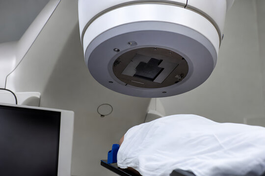 Radiotherapy gantry above patient on treatment couch