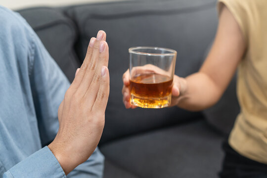 man refuse to drink alcohol say no to his friend.