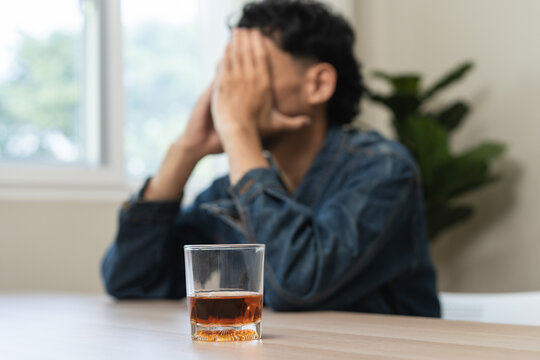 depression and anxiety woman drinking whisky alone.