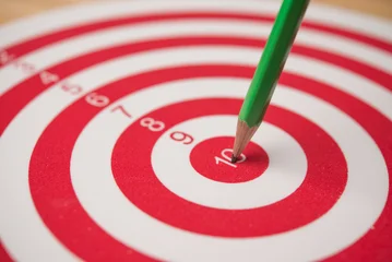 Closeup red pencil hit to the center of dartboard. Success target in the education, graduated from university, high score or pass the examination, get a scholarship, get the good job and so on concept © pla2na
