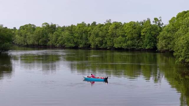 Fisherman In Small Boat On Sungai Pulai River