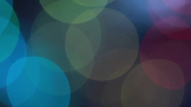 Soft abstract colorful bokeh orbs create a blurred light background ideal for festive celebratory decorative overlay designs