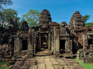 Fototapeta premium Ancient Stone Corridor with Aligned Doorways at Banteay Kdei Temple, Angkor, Cambodia