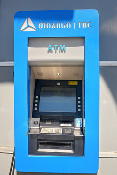 Batumi, Georgia - June 15, 2026: Blue TBC bank atm machine with digital screen showing financial services and transactions options in gel and usd, installed on city street.