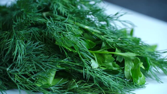 Fresh organic dill and parsley bunch lying on a clean white kitchen surface, a detailed macro shot showcasing vibrant green leaves with water droplets, ready for cooking and seasoning
