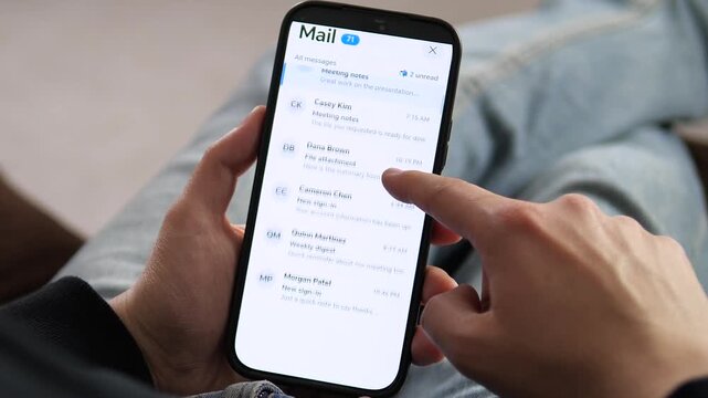 Mobile email inbox scrolling. Hand navigating through business messages, salary confirmations, and work updates. Perfect for remote work, digital productivity, and corporate lifestyle B-roll.