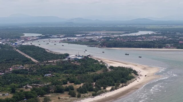 Aerial perspective captures a coastal river delta and sandy shoreline