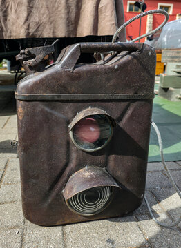 Vintage German military railway signal lantern made in a jerrycan shape with colored lenses displayed in a historical setting