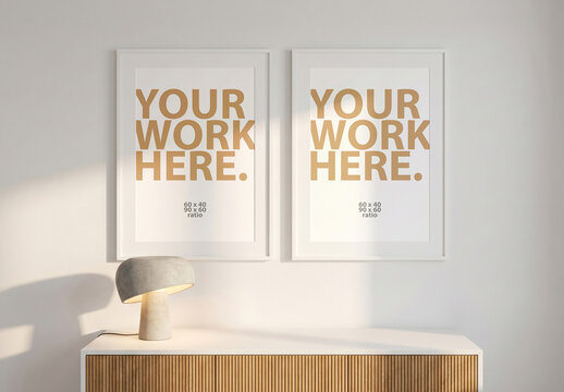 Two Vertical Posters Mockup in frame above console with concrete lamp