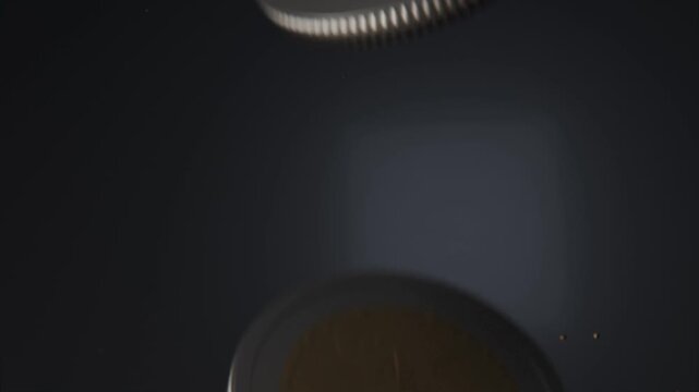 Spinning bimetallic coin entering upper-right, drifting over navy glow, revealing embossed face