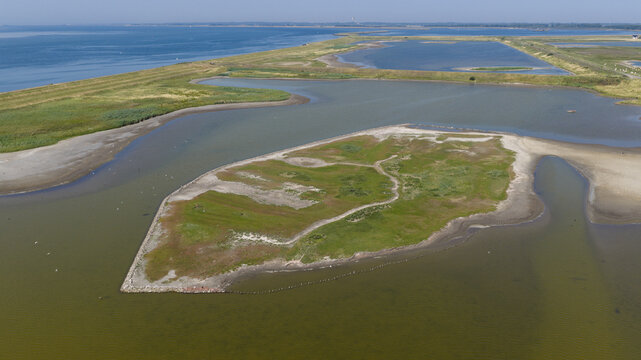 Aerial view of Plan Tureluur nature reserve featuring marshy islands, wetlands, and coastal waters in Kerkwerve, Zeeland, Netherlands.