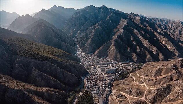 Aerial view of Hatta town aerial cityscape surrounded by Hajar mountains in Hatta enclave of Dubai in the United Arab Emirates.
