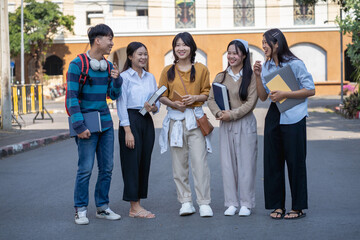Fototapeta premium Diverse group of young students enjoying a vibrant conversation in an outdoor urban environment