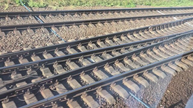 Railway tracks stretching into the distance with perspective in natural daylight