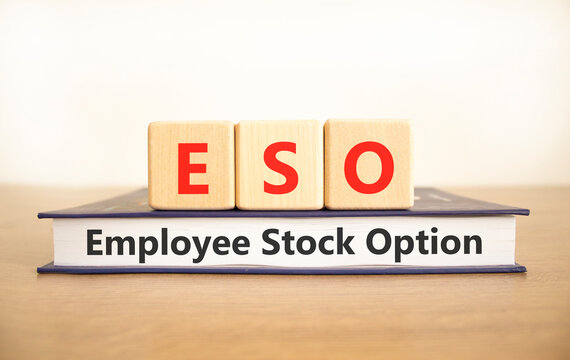 ESO employee stock option symbol. Concept words ESO employee stock option on beautiful wooden blocks and book. Beautiful white background. Business ESO employee stock option concept. Copy space.