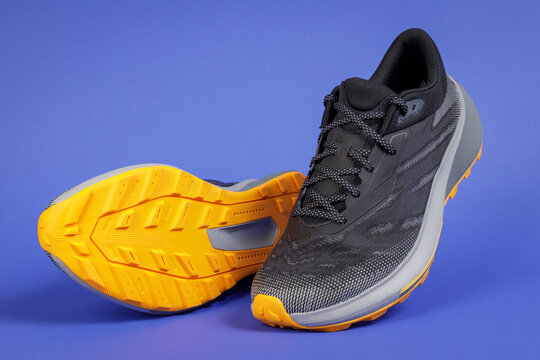 Running sports shoes on purple background. Running shoes, sneakers or trainers. athletic shoes. fitness, sport, training concept.
