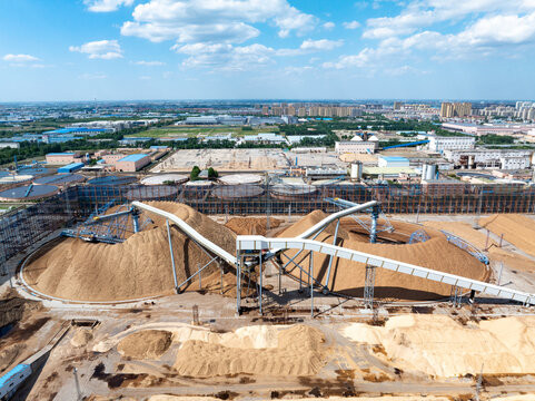Aerial view of large paper mill raw material stockyard with conveyor belt system