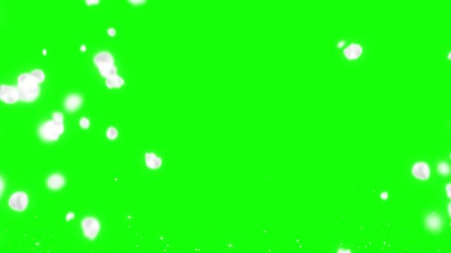 Snow falling on green screen background with white specks