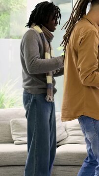 Vertical video: Checking headset braided man passing white VRs at home fitting onto her peach scarf
