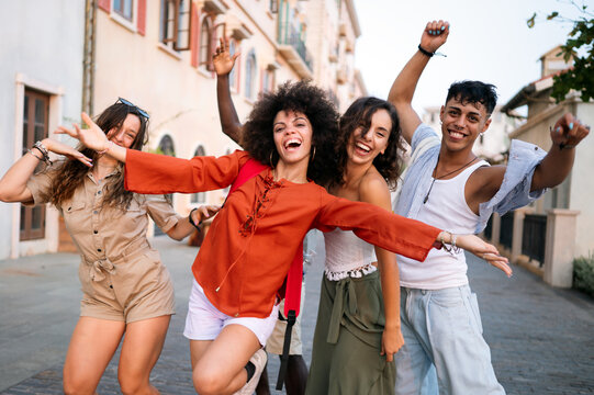 Happy group of friends enjoys a relaxed summer afternoon exploring the city during a fun sightseeing