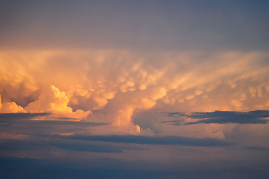 Mammatus convective cumulonimbus clouds in hot weather, a precursor to thunderstorm instability in the troposphere.