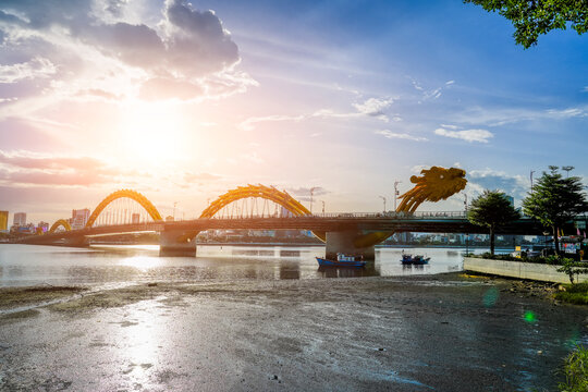 Dragon bridge at sunset time evening golden hour beautiful clouds over mountains