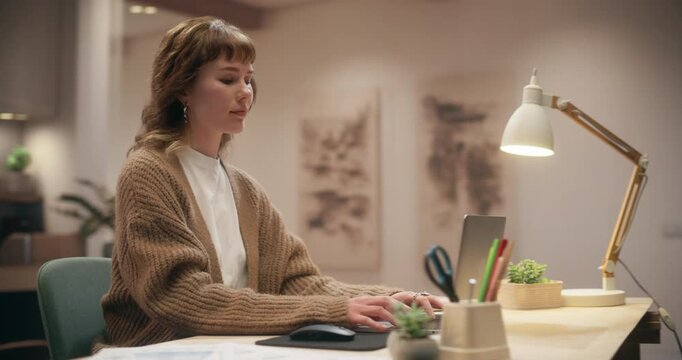 360 Degree. Young Caucasian Female Working on Laptop Computer at Home Desk, Typing Emails, Browsing Internet, Online Shopping and Studying in Warm Cozy Apartment Workspace. Cinematic Arc Tracking Shot