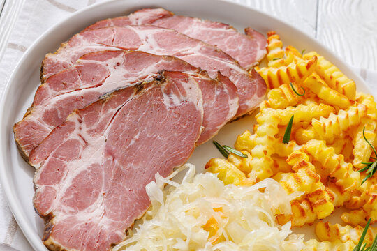 pork neck slices with sour cabbage, french fries