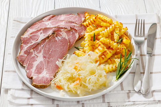 pork neck slices with sour cabbage, french fries