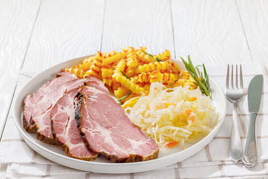 pork neck slices with sour cabbage, french fries