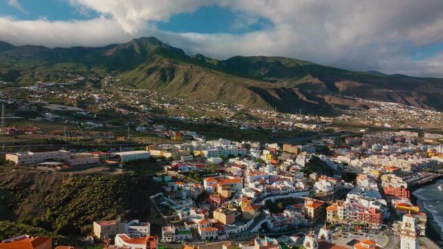 The aerial view of picturesque coastal town Candelaria with volcanic mountain range in the background, Tenerife