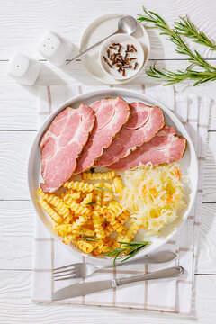pork neck slices with sour cabbage, french fries
