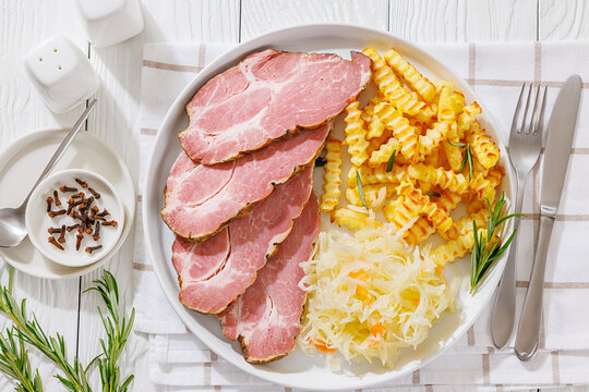 pork neck slices with sour cabbage, french fries