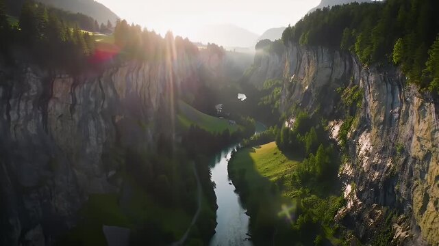 A breathtaking aerial view captures a serene river winding through a lush valley flanked by towering, sun-drenched cliffs.