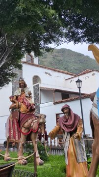 Traditional outdoor Christmas display with statues of the Three Wise Men riding camels in a public park square, celebrating the Epiphany holiday in Tenerife, Canary Islands, Spain.