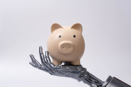 Futuristic robotic hand holding piggy bank, symbolizing artificial intelligence in finance, smart savings, digital banking, investment technology, and automated money management solutions.
