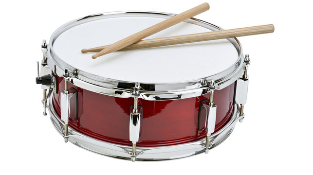 Red snare drum with wooden drumsticks on white surface
