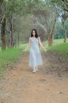 Elegant woman in white outfit enjoying nature in Khao Yai, Thailand