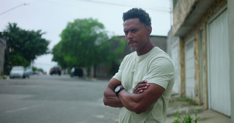 Fototapeta premium Hispanic Afro-Latin man angrily discussing with someone off camera, expressive gestures, intense conversation, frustration, serious expression, urban street setting, argument