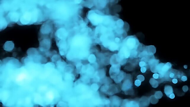 Abstract bright blue bokeh lights on black background.