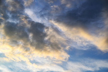 Fototapeta premium Dramatic sky at sunset with dark storm clouds and golden light