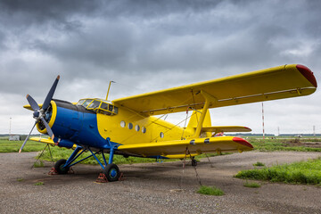 Yellow retro passenger biplane at the airfield © Dushlik