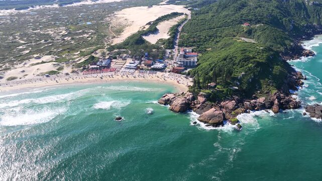 Aerial panorama of Joaquina Beach, white sand dunes, and Atlantic coastline in Florian&oacute;polis.