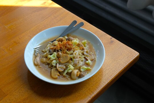 Mie Jamur or Oriental Curly Noodles with Mushroom in owl. Perfect for restaurant menus, food branding, and Asian culinary concepts.